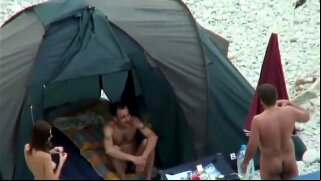 Peeping on nudists is a fun activity because, surprisingly, they are nude. Joking aside, this small beach camp was crowded with sexy naked ladies and those guys were walking around with their limp dicks, probably exhausted from fucking them all the time.