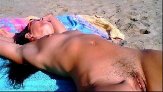 Step onto the sandy beach and experience the allure of a seductive, mature brunette. Watch as she teases and strips, revealing her natural beauty. You won't be able to resist her perky charm.